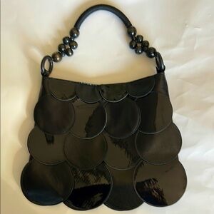 Black shoulder bag, faux leather and patent leather scalloped design.